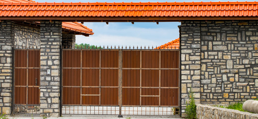 brown forged automatic gates in the cottage