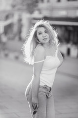 Portrait Beautiful young blonde girl in sunglasses with puffy lips and sexy feminine body posing on...