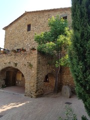 Fototapeta na wymiar Amazing stone house with nice trees at Monells, Catalonia