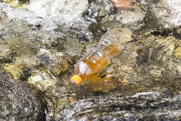 Plastic bottle is on the stream