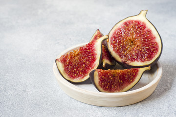 Fresh figs cut into a plate with copy space