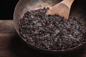 Roasted coffee beans with wooden spoon