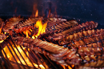 Pork Ribs Cooking On Grill Closeup