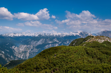 Triglav National park mountains with a small house on top of the green hills