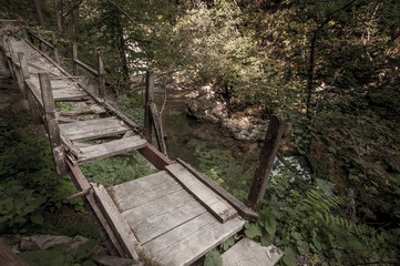 Broken walking bridge over the river