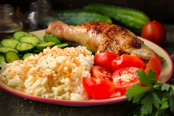 Grilled chicken leg, white rice, slised cucumber with sesame seeds, tomtoes and herbs.