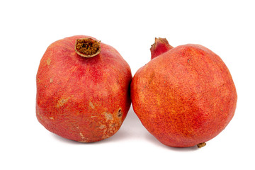 Two pomegranates leaning on eachother with a white background (isolated)