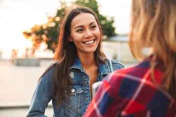 Close up of a smiling asian woman talking to her girl