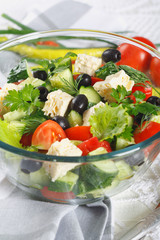 Salad of fresh vegetables and cheese on  served table