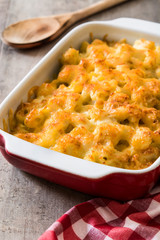 Typical American macaroni and cheese on wooden table