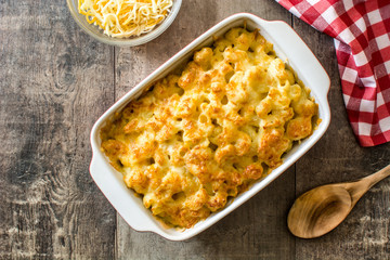 Typical American macaroni and cheese on wooden table. Top view