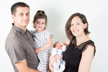 happy family of four with two children baby son and daughter on white background