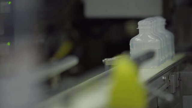 Sterilized clogged plastic bottles with medicine on the conveyor of Blow fill seal technology technique used to produce liquid-filled container on a medical or food industrial factory