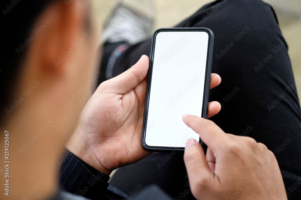 Wall mural man using smartphone. blank screen mobile phone for graphic display montage.