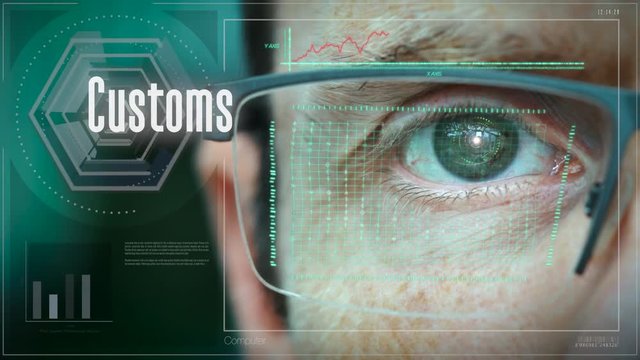 A close up of a businessman eye controlling a futuristic computer system with an Customs concept.