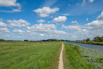Panorama view, cloudy blue sky above a polder.