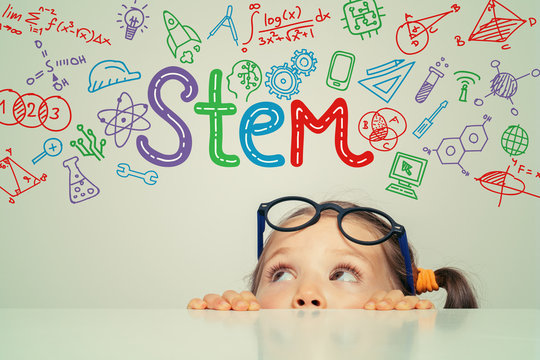 STEM word and symbols over beautiful cute little girl. modern education concept