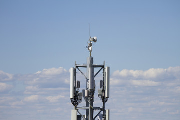 Cell phone tower on blue sky. Communication tower or 3G 4G network telephone cellsite
