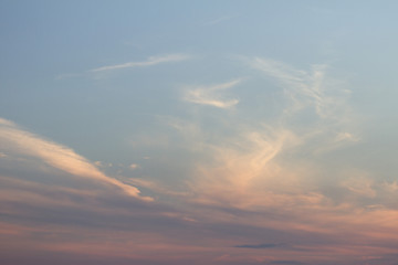 Sky clouds background. Cumulus clouds in the sunset. Color clouds in the evening. Sky with a pastel colored background