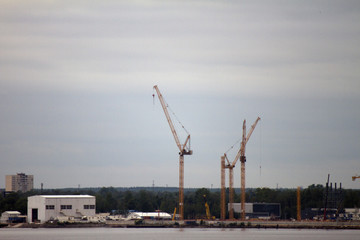 Fototapeta na wymiar Tower crane. Industrial landscape. Three cranes working during construction
