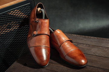 Elegant brown monk shoes with double strap on a wooden table