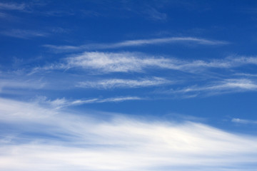 Naklejka na ściany i meble Sky clouds background. Spindrift white clouds in the blue sky in the morning