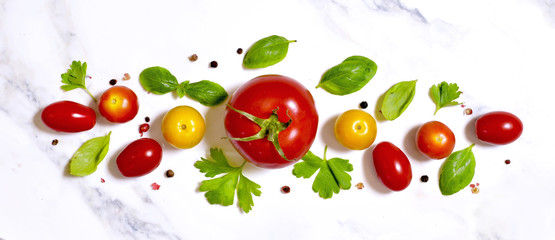 Delicious fresh tomatoes on a white marble stone background. Top view with copy space.