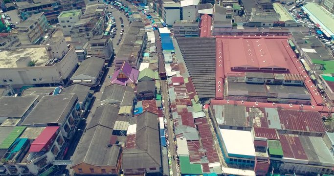 train passing through Maeklong Railway Market to reach Mahachai Station aerial view, Thailand
