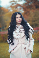Beautiful woman wearing fashion coat in autumn outdoors