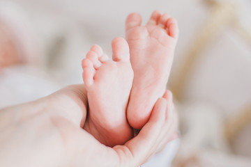 Little baby feet on a swaddle blanket