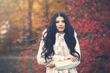 Fototapeta na wymiar Beautiful woman outdoors in autumn park