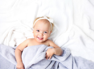 Baby child in bed covering with blanket empty space. © nys
