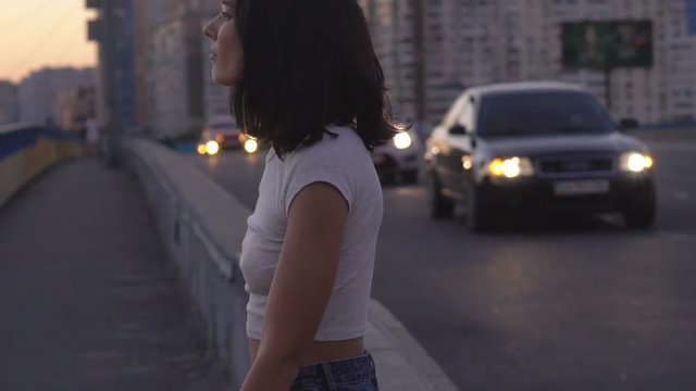 young nice teenage girl walking along the track. A brunette woman with a stitch. Attractive woman in stylish clothes. HD Slowmotion