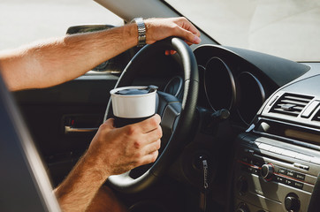 traveling on the road, drinks and people in the car with cups of coffee