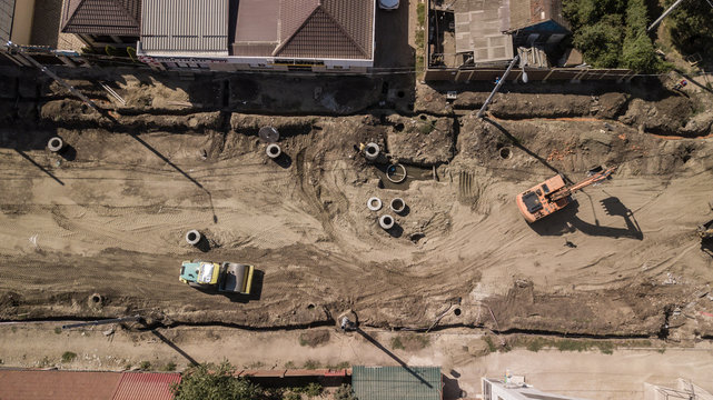 Aerial construction site with machinery. Top down view of city building site.