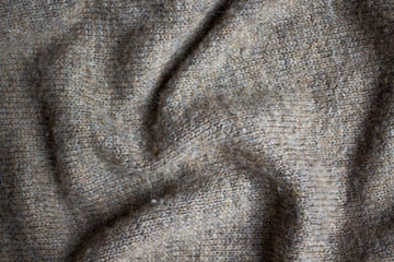 the texture of a knitted sweater, close up warm woollen clothing