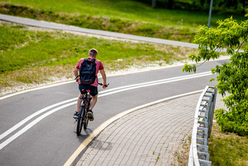 Cyclist ride on the bike path in the city Park 