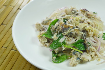 spicy minced mackerel with herb Thai salad on dish
