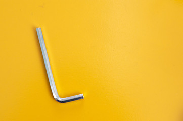 Allen key on yellow background - 219141436