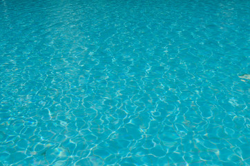 Fototapeta na wymiar Blue ripple water on swimming pool