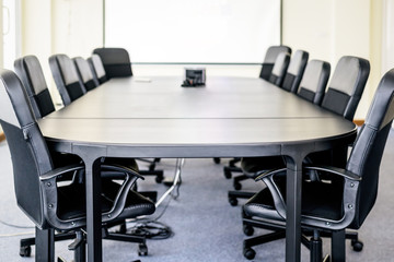 Empty Business Meeting Room and Conference Table with White Projector Board