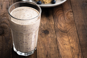 chocolate with blueberry smoothie in a glass on a rustic table

