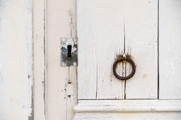 White vintage door with lock and knocker, old texture