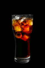 One-color, red, brown, transparent cocktail with ice cubes. Isolated black background. Side view. Drink in a glass glass for the menu restaurant, bar, cafe