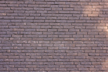 Infinite brown brick wall as background