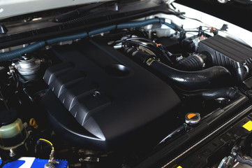 Fototapeta premium closeup detail of new car engine with soft-focus and over light in the background