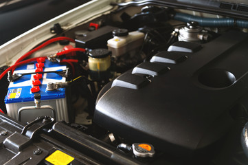 closeup detail of new car engine with soft-focus and over light in the background