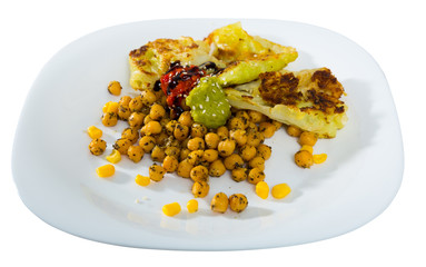 Photography of plate with cabbage leaves in batter with garbanzos and sauce