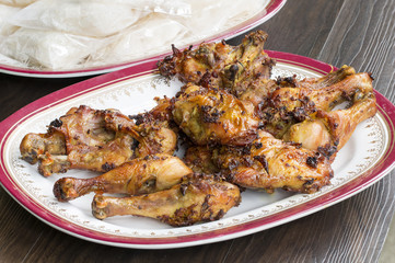 Thai food and traditional menu.Roast chicken and sticky rice with dish on wood.Close up.