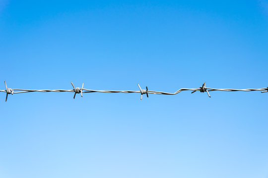 barbed wire on blue sky background